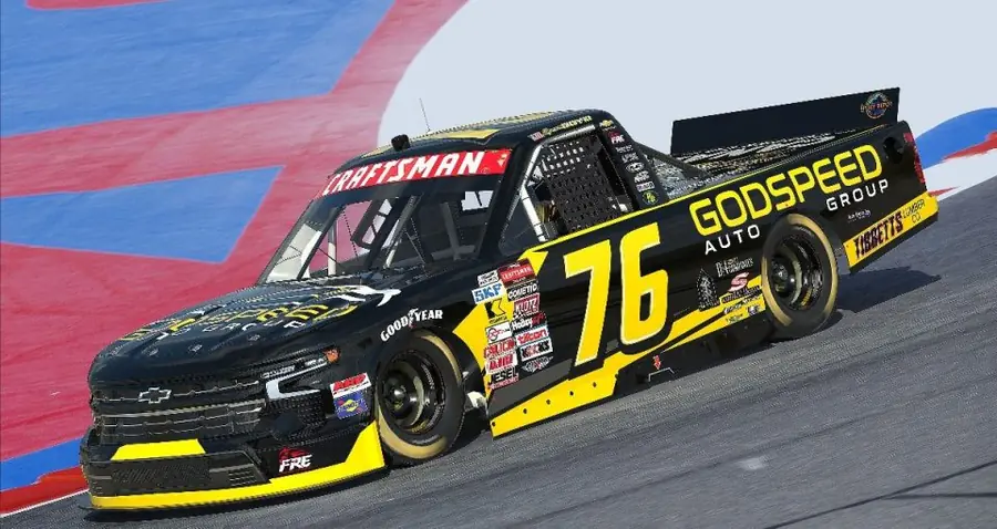 The No. 76 Freedom Racing Enterprise Chevrolet Silverado in Godspeed Auto Group black and yellow livery on track
